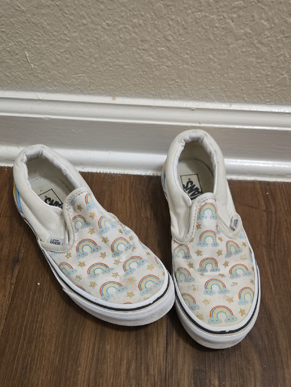 Vans Kids Slip-On Sneakers in White with Rainbow & Gold Star Print